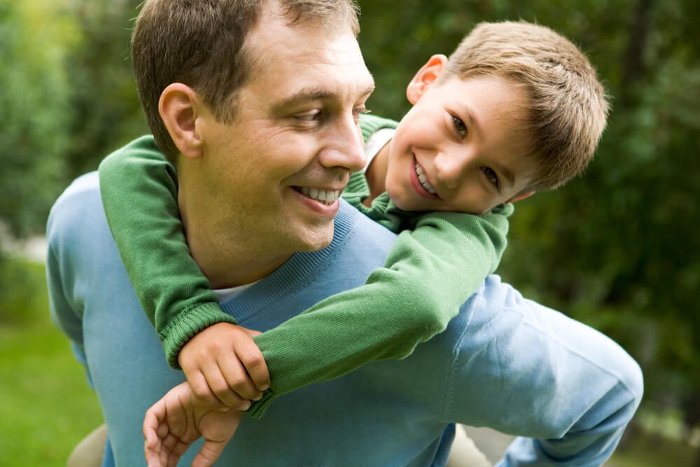 A man and boy are smiling for the camera.