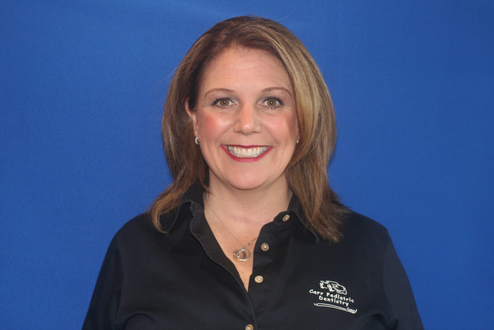 A woman with long hair wearing a black shirt.